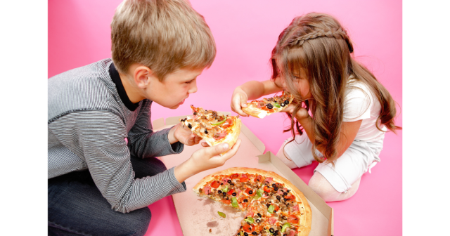 boy and girl eating pizza