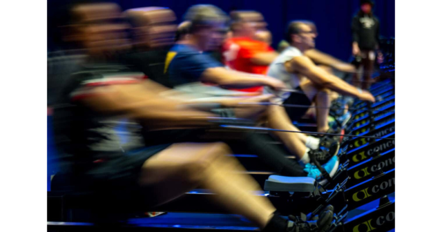 blurred image of an indoor rowing race