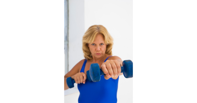 woman punching with dumbbells