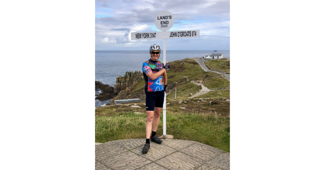Edward in cycling kit at Lands End post