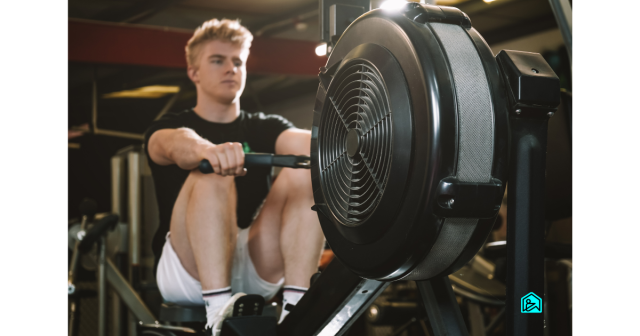 young man rowing on the rowing machine