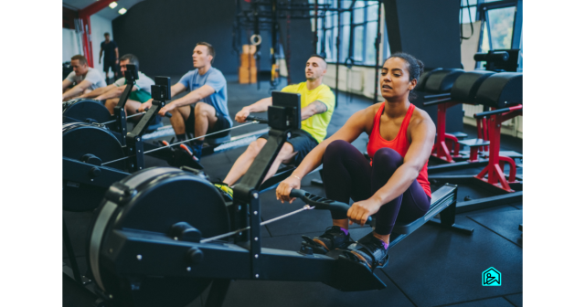 mixed sex of people on rowing machines rowing