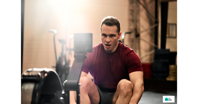 Young male athlete breathing heavily after a Zone 3 rowing training session