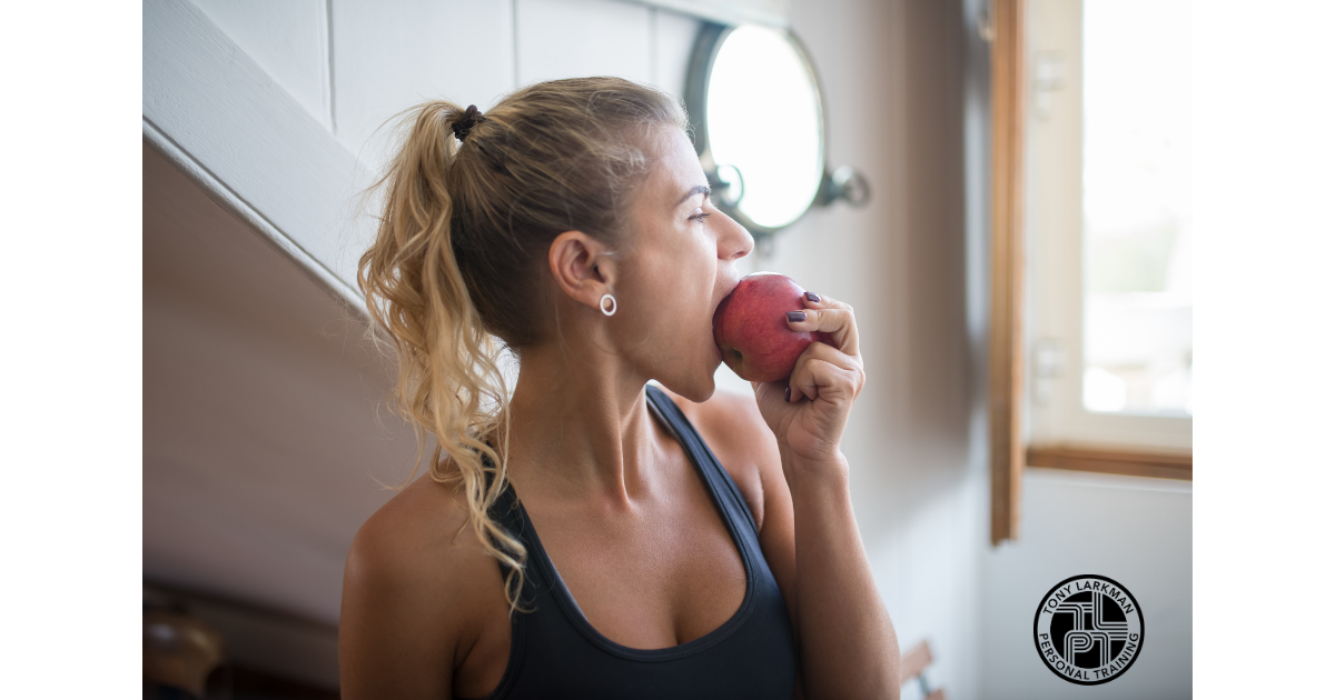 Healthy woman eating an apple as part of a balanced lifestyle