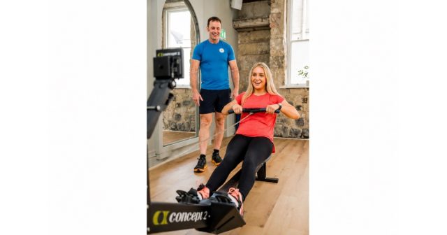 Tony Larkman coaching a client on a Concept2 rowing machine during a personalised indoor rowing training session