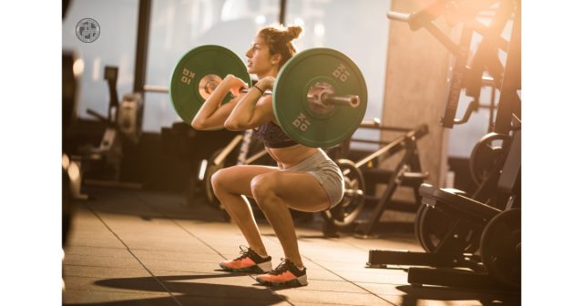 Athlete performing a front squat to develop strength and power for improved rowing performance and faster 2K times