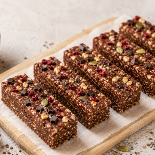 Homemade organic high-protein recovery bars made with whey protein, oats, almonds, chia seeds, flaxseed and Medjool dates.