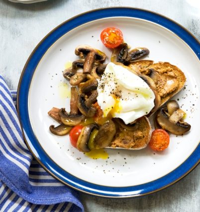 nutty mushrooms egg cherry tomatoes and toast on plate