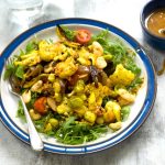 turmeric roasted cauliflower, sprout and butterbean salad on a plate and sauce