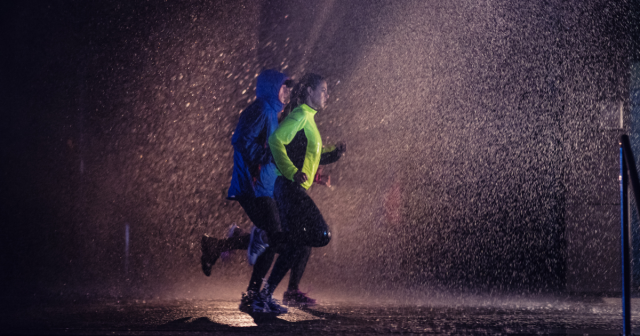 man and woman running in the cold in the dark and sleet