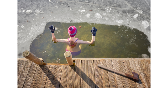 Woman entering an ice break on a frozen pond
