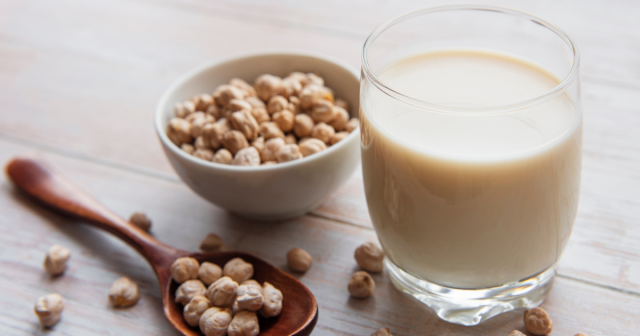 glass of pea milk and bowl of peas