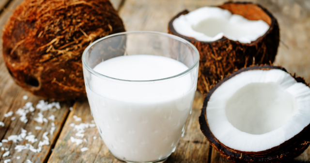 glass of coconut drink and coconuts