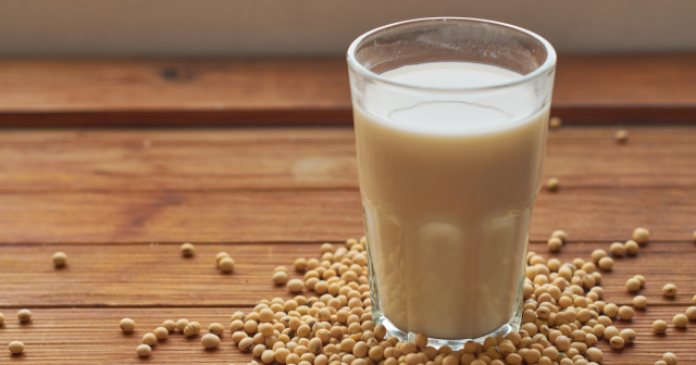 glass of soya milk and soya beans