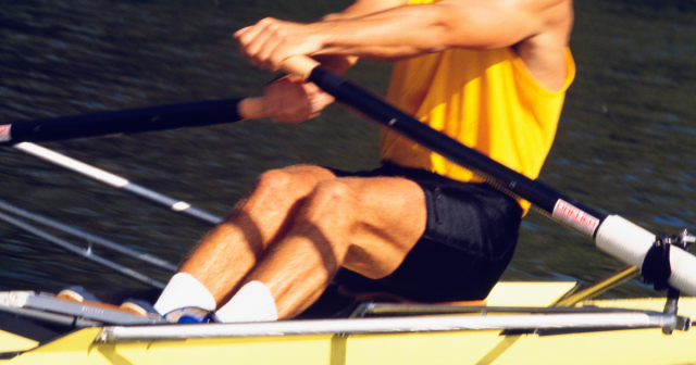man rowing in single scull
