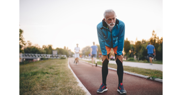 older man recovering from track sprint