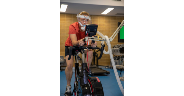 woman performing a vo2max test on a stationary bike